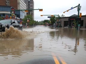 A pickup truck roars through a flooded out street in Calgary early Friday. (JIM WELLS/QMI Agency)