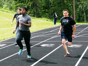 Rev St-Laurent leads Evan James (right) and Jack Fath down the track as they work on their 100 metre skills in preparation for this weekend’s event. - Gord Montgomery, Reporter/Examiner