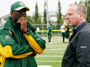 Edmonton Eskimos head coach Kavis Read (left) and club president/CEO Len Rhodes  both appreciate the quality of turf at Fuhr Sports Park in the Grove and will be back for their full training camp in the spring of 2015. - Gord Montgomery