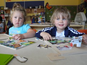 Kasianna Renaud and Maxime Merizzi work on puzzles at the child care centre in Rose de Vents school, which is slated to add at least 10 toddler spaces thanks to provincial funding. CHERYL BRINK staff photo