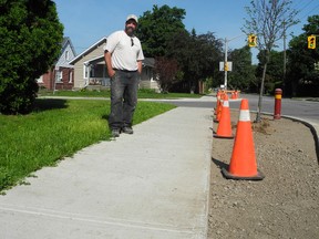 Carlos Da Costa is pleased the city is working to repair a poor sodding and grass restoration left at Terrace Hill Street and Lyons Avenue after work done several years ago. (HUGO RODRIGUES Brantford Expositor)