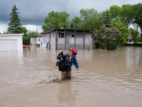 High River Times reporter, Taylor Weaver, saved what he could from his apartment before water levels got too high on Thursday afternoon in High River, Alberta.
CHRIS BOLIN/THE GLOBE AND MAIL