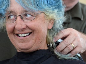 Shirley Miller's blue hair is shaved off by Craig Glover Saturday afternoon outside Tangles Salon in Tillsonburg. A local team of 10 have raised $2,000 (so far) for Make-A-Wish. CHRIS ABBOTT/TILLSONBURG NEWS
