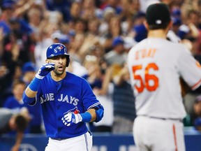 Blue Jays outfielder Jose Bautista gestures towards Orioles pitcher Darren O'Day after he hitting a home run at the Rogers Centre in Toronto, June 22, 2013. (MARK BLINCH/Reuters)