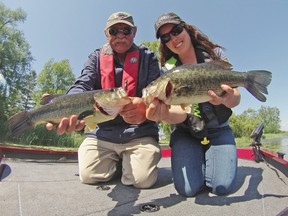 Jack Rae, left, and Ashley Rae display some largemouth bass caught and released on the Bay of Quinte on the opening day of the bass season. 
Submitted photo