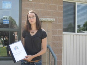 An Oxford People Against the Landfill (OPAL) representative holds a copy of the group's comments on draft terms of reference for environmental assessment of the proposal by Walker Environmental Group to convert a mined lime quarry in the Township of Zorra into a landfill. The group arrived at Walker's Ingersoll office on Friday, June 21, the deadline day for public submissions to find the office closed despite a sign on the door that said "open, come in." Walker project manager Joe Lyng said the office on Carnegie Street is always closed on Fridays. CONTRIBUTED PHOTO