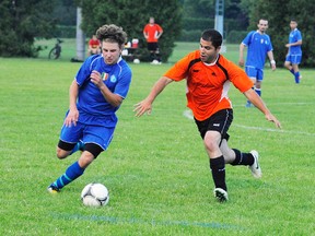 MONTE SONNENBERG Simcoe Reformer
Nuno DaSilva of the Norfolk Athletics, right, challenges a Curinga player for the ball during WOSL Fourth division play in Delhi Saturday. Norfolk staked out a 2-0 half-time lead and hung on for a 3-2 win against the visitors from London.