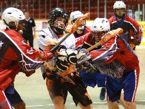 Owen Sound North Stars' Brett McCulloch, centre, gets sandwiched between Welland Warriors' Eric Masters, left,  and David Falova, right, after getting a shot off during Junior B lacrosse action on Saturday, June 22, 2013 at the Lumley Bayshore in Owen Sound.