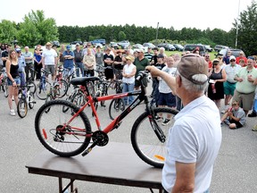 Bob Mitchell holds one of the nearly 200 bikes available at the annual Chatham-Kent Police Service Auction Saturday morning. The auction, which featured an assortment of bikes, jewelry, electronics and tools raised approximately $9,000. (DIANA MARTIN, The Daily News)