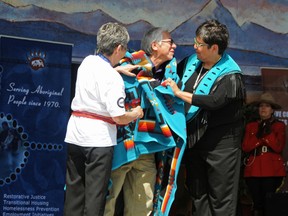 Elizabeth McSheffrey/Daily Herald-Tribune
Aboriginal Elder Edward Ferguson is honoured with the gift of a blanket from Métis Local 1990 president Angie Crerar (left) and Marge Mueller, regional manager for Native Counselling Services of Alberta. The ceremony took place during Grande Prairie’s 2013 National Aboriginal Day festivities in Muskoseepi Park on Sunday.