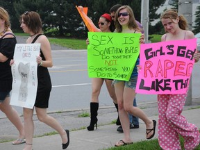 Signs and placards were carried by participants in Belleville's Slut Walk Sunday. A few dozen people marched in the event which mirrored similar walks in other cities. W. BRICE MCVICAR/The Intelligencer/QMI Agency