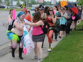 Participants in the Slut Walk make their way down Bell Boulevard. The event divided people as some said the message needs to be delivered while others were offended by some of the scantily clad women in the group W. BRICE MCVICAR/The Intelligencer/QMI Agency