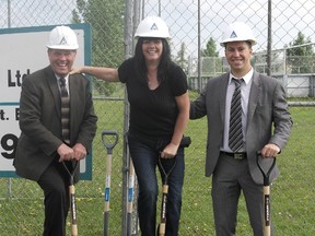 Callingwood/Lymburn community league president Terry Demers (centre) poses with representatives from Hendricks Construction at the future site of the Callingwood/Lymburn community hall in West Edmonton, on June 21, 2013. Photo Supplied.