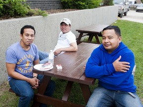 TAYLOR WEAVER HIGH RIVER TIMES/QMI AGENCY
Genaro Sumbanon, Jeremias Daen and Richard Rubicruz get some fresh air and lunch after being evacuated to the Tom Hornecker Arena in Nanton among many other High Riverites. Sumbanon and Rubicruz have been living in Canada for one week.
