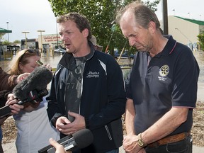 TAYLOR WEAVER HIGH RIVER TIMES/QMI AGENCY Alberta Emergency Management Agency Minister of Municipal Affairs, Doug Griffiths stands with High River Mayor, Emile Blokland during a press conference on 18 ST SE, Sunday, June 23.