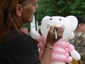 Maddy Ouellett of All Blown Up Balloons in Melfort came out to make balloon creations for the kids at the Party in the Park fundraiser in Love on June 22.  A large percentage of the proceeds were donated to Love's cause.  Here she is adding the final touches to a Hello Kitty balloon that she twisted into shape.