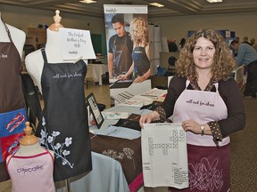 Lee Overton, co-owner of Domistyle shows her aprons and kitchen textiles at the Enterprise Brant trade show on Thursday, April 25, 2013 at the Brant Park Inn in Brantford. (BRIAN THOMPSON Brantford Expositor)