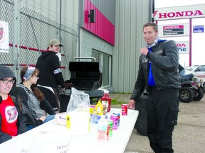 Meredith McDonald waits for a burger during a stopover in Cold Lake. McDonald was one of 32 riders raising money for research into Angelman Syndrome.