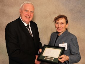 Mary-Jane Brown of MJ Brown Certified General Accountant, Paris, Ontario, was presented with a 20-year award plaque for 20 years of owning and operating her own business. She was presented with the plaque by Otto Heinzl at the Spring Trade Fair held by Enterprise Brant earlier this year.