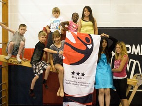 Students proudly display a banner from Physical and Health Education Canada (PHE Canada), Monday, recognizing La Verendrye School for a National Award for Quality Physical Education for the 15th year in a row. (ROBIN DUDGEON/PORTAGE DAILY GRAPHIC/QMI AGENCY)
