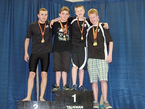 Silver Tide swimmers Nathan Smith, Mathew Smith, Leighton Janzen and Brendan Byers display their medals from the Swim Alberta Age Group Trials. Photo supplied
