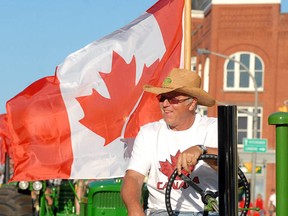 Ron Neeb drives a John Deere tractor in last year's Canada Day parade in downtown Stratford. (SCOTT WISHART, The Beacon Herald)