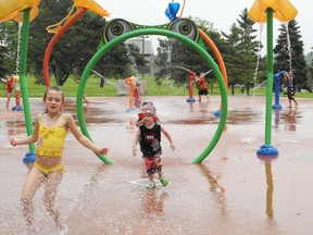 Arianne Leroux Gaucher, 6, (at left) and three-year-old Chace Seguin race through the splash pad in Cornwall’s Lamoureux Park on Monday to beat the humidity in the air. The region is under a heat advisory for the next few days.
KATHRYN BURNHAM staff photo