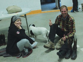 Denise Moore sits with her rescuer Tom Brinkman at the Tom Hornecker Recreation Centre evacuation centre. Both were happy to be dry, warm and have shoes on their feet.