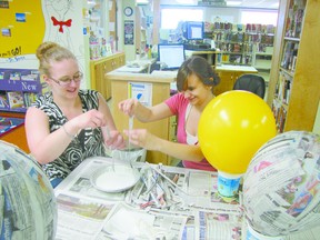 Talisa Gibbs, left, Mayerthorpe Public Library employee, and Darsi Hall, the library’s C.A.P. (Community Access Program) youth intern, prepare pinatas to be used on July 16 and 17 for the summer reading program which runs from July 9 to into August. C.A.P. internships are a federal government initiative intended to provide employment opportunities for Canadians between the ages of 15 and 30, primarily students such as Hall.