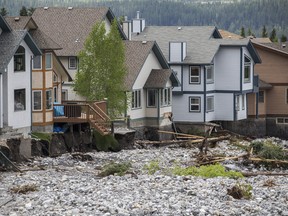 Premier Alison Redford says primary residence home owners will be "fully compensated" for following Cougar Creek flooding. Justin Parsons/ Canmore Leader/ QMI Agency