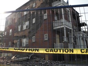 Yellow caution tape and blue fencing surrounds an apartment building on Cumberland Street on Monday that was ravaged by a fire on Friday evening.
Cheryl Brink staff photo