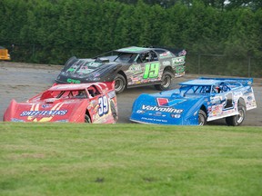 A trio of World of Outlaws late model cars are in tight quarters during a turn at the Cornwall Motor Speedway, Sunday. Robert Lefebvre photo (www.icelevel.com)