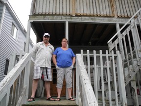 Brian Lalonde and Deborah Mulley on the back porch of their Easton Street apartment. They wants repairs made to where they live, and after making complaints to the city, a meeting is set for today between the landlord and bylaw officials.
KATHRYN BURNHAM staff photo