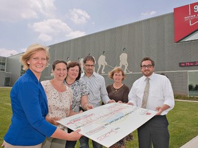 SC Johnson community enrichment team members Heather Barker (left), Kathy Makela, Rebeccah Bohlender and Robert Nasato present a cheque for $200,000 from SC Johnson to Trudy Ion, a volunteer on the sponsorship fundraising committee at the Wayne Gretzky Sports Centre, and Brantford Mayor Chris Friel.  The money will be used to design and construct a family-friendly green space in the area near the centre's new front entrance. (Brian Thompson, The Expositor)