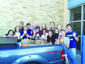 Catholic Central students stuffed the classroom of teacher Jim Sweeney, sixth from left, with 215 kilograms of food in a year-end prank ? enough to fill the back of a pickup. (Special to The Free Press)
