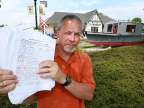 Richard Thomas holds up pages of petitions with hundreds of signatures in support of keeping the Owen Sound Marine and Rail Museum in the former CN Railway station in Owen Sound on Monday, June 24, 2013. Thomas was to present them to Owen Sound council on Monday night.  (JAMES MASTERS/QMI Agency/The Sun Times)