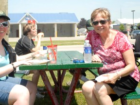 Kendra Carter and Christine Romign enjoyed a BBQ celebration following a walk around the Square with the Flame of Hope when it passed through Goderich June 24.