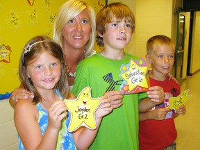 Jayden Smith (left), a Grade 2 student at St. Frances Catholic school, Sebastian Barham, a Grade 6 student, and Griffyn Kochany, a Grade 2 student, hold their Mathletics Gold Stars they achieved for completing a math computer program. With them is Grade 2 teacher Leanne Howse. School ends for the summer this week. (DANIEL R. PEARCE Delhi News-Record)