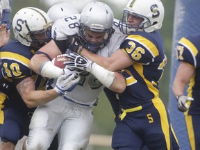 STEELER STOP – Matt Gauthier (40) and Justin Sauerzopf (36) of the Sault Steelers stop Joshua Cuomo (28) of the Sudbury Spartans during Northern Football Conference action on Saturday at Rocky DiPietro Field. The Steelers won, 69-7.