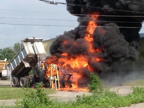 A city dump truck is engulfed in flames in this reader-submitted photo.