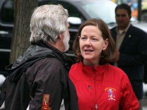 Premier Alison Redford speaks to Canmore Mayor John Borrowman outside the Canmore Civic Centre Monday afternoon, June 24, 2013. Dave Husdal/ For the Leader