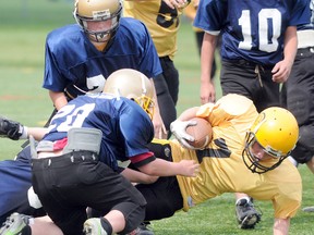 Centre Hastings McConnell Funeral Home Centurions' quarterback Liam Madden dives into the end zone during the Centurionsí 26-6 win over the Scott's Haulage-Diamond Electric Rough Riders in the Belleville Minor Football League's 'D' championship game, Saturday at M.A. Sills Park.