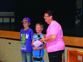 NESPCA board member Jessie Harper accepts a donation cheque from students at Central Park School on June 20.