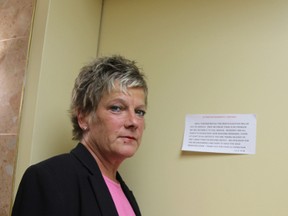 Nancy Bell of Sarnia stands outside the elevator she was trapped in for nearly three hours on Saturday. The elevator has since been taken out of service, but Building Manager Randy Ripley has not received an answer about when the elevator will be fixed. (LIZ BERNIER, The Observer)
