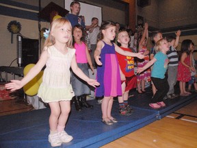 DANIEL R. PEARCE Times-Reformer

Abby Turvey (left), Claire Alvey, and Corey Balogh lead a group of junior kindergarten students at West Lynn public school in Simcoe in song during the kindergarten graduation ceremony held on Tuesday afternoon.