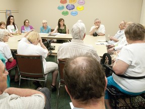 Teresa Armstrong, centre back, the NDP MPP for London-Fanshawe, listens to concerns over the closing of a hydrotherapy pool at St. Joseph?s Hospital during a meeting at the Cherryhill branch of the London Public Library on Tuesday. (CRAIG GLOVER, The London Free Press)