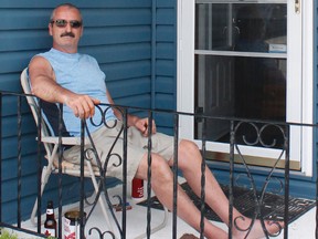 Gilles Faubert sits on the steps of his Wende Avenue home in the South end of Timmins. Early Monday morning, he chased down and tackled a robbery suspect trying to make off with items from his neighbour’s truck. The suspect was subsequently arrested by Timmins Police Service.