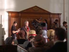 Cast and crew prepare to shoot another take inside Christ Church at Upper Canada Village on Tuesday, where the movie Tell the World is being filmed.
Cheryl Brink staff photo