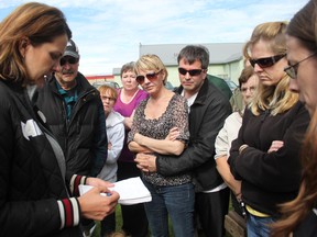 Wildrose leader and Highwood MLA Danielle Smith shows evacuated High River residents a rough sketch of the Town of High River. The town has been portioned into hardest hit areas and how this works for the re-entry plan. The informal meeting was held at Centennial Park in Nanton June 24.