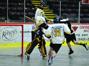 Kingston Kings' Zack Masterson puts one of his two goals past Brockville Ballistic goalie Colin Halladay, as Brockville's Scott Stranges races back in Ontario Jr. C Lacrosse action Tuesday night at the Memorial Centre. The Ballistic fell 8-4. (STEVE PETTIBONE The Recorder and Times)